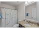 Bathroom featuring granite countertops, a shower and tub with patterned shower curtain at 9867 Travertine Trl, Davidson, NC 28036