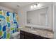 Bathroom showcases granite countertop, a large framed mirror, and a whale themed shower curtain at 9867 Travertine Trl, Davidson, NC 28036