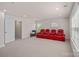 Spacious carpeted bonus room with row of four recliners and natural light at 9867 Travertine Trl, Davidson, NC 28036