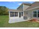Rear exterior featuring a screened in porch and concrete patio at 9867 Travertine Trl, Davidson, NC 28036