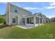 Rear exterior featuring a screened in porch and concrete patio at 9867 Travertine Trl, Davidson, NC 28036