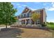 Beautiful brick home boasts lush landscaping with vibrant flowers and a well-maintained lawn at 9867 Travertine Trl, Davidson, NC 28036