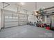 Spacious two car garage with epoxy flooring and overhead storage shelves at 9867 Travertine Trl, Davidson, NC 28036