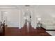 Elegant hallway with dark wood floors, white trim, and a glimpse of a living space at 9867 Travertine Trl, Davidson, NC 28036