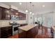 Bright kitchen features granite countertops, wooden cabinets, stainless steel appliances, and a breakfast nook area at 9867 Travertine Trl, Davidson, NC 28036