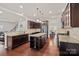 Kitchen with dark wood cabinets, granite countertops, stainless steel appliances, island, and an attached dining area at 9867 Travertine Trl, Davidson, NC 28036