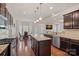 Open kitchen design featuring granite countertops, stainless steel appliances, wooden cabinets and breakfast nook dining area at 9867 Travertine Trl, Davidson, NC 28036
