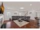 Spacious living room with dark wood floors, a leather sectional, and a cozy atmosphere at 9867 Travertine Trl, Davidson, NC 28036