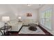 Cozy living room with hardwood floors, neutral furniture, and a bright window view at 9867 Travertine Trl, Davidson, NC 28036