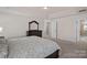 Bright, carpeted main bedroom with tray ceilings and ensuite bathroom at 9867 Travertine Trl, Davidson, NC 28036