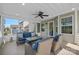 Relaxing sunroom with tile flooring, ceiling fan and comfortable seating, overlooking backyard at 9867 Travertine Trl, Davidson, NC 28036