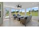 Relaxing sunroom with tile flooring, ceiling fan and comfortable seating, overlooking backyard at 9867 Travertine Trl, Davidson, NC 28036