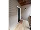 Cozy front entrance features a wooden deck with a black door with gold accents, and exterior light at 10005 Graduate Ln, Charlotte, NC 28262
