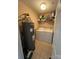 Well organized laundry area with a washer, dryer, water heater, and shelving at 10005 Graduate Ln, Charlotte, NC 28262