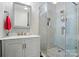 Stylish bathroom features a glass-enclosed shower with gray patterned tiling and a gray vanity with a marble countertop at 10056 Paisley Dr, Charlotte, NC 28269
