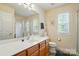 Bright bathroom with a glass-enclosed shower, large mirror, and wood vanity at 10056 Paisley Dr, Charlotte, NC 28269