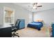 Cozy bedroom featuring a blue comforter set, windows with blinds, and modern decor at 10056 Paisley Dr, Charlotte, NC 28269