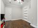 Neutral bedroom with hardwood floors features built-in shelving and a door to the hallway at 10056 Paisley Dr, Charlotte, NC 28269