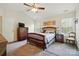 Relaxing bedroom with a wooden bed, dresser, and ample natural light from the windows at 10056 Paisley Dr, Charlotte, NC 28269