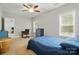 Cozy bedroom featuring a blue comforter set, a desk, and natural light at 10056 Paisley Dr, Charlotte, NC 28269