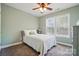 Serene bedroom with white bedding, soft green walls, and natural light from windows at 10056 Paisley Dr, Charlotte, NC 28269
