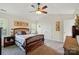 Cozy bedroom with a wooden bed frame, vaulted ceiling, and ceiling fan at 10056 Paisley Dr, Charlotte, NC 28269
