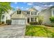 Charming two-story home featuring a two-car garage and manicured lawn at 10056 Paisley Dr, Charlotte, NC 28269