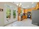 Well-lit kitchen with stainless steel appliances and access to the deck via glass doors at 10056 Paisley Dr, Charlotte, NC 28269