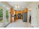 Spacious kitchen featuring stainless steel appliances and access to an outdoor deck at 10056 Paisley Dr, Charlotte, NC 28269