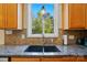 Bright kitchen showcasing a granite countertop and a double basin sink beneath a large window at 10056 Paisley Dr, Charlotte, NC 28269