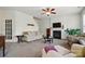 Comfortable living room with a fireplace, ceiling fan, and neutral-toned furniture at 10056 Paisley Dr, Charlotte, NC 28269