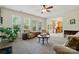 Sunlit living room with large windows, comfortable seating, and an open flow to the kitchen at 10056 Paisley Dr, Charlotte, NC 28269