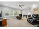 Spacious living room with multiple windows, hardwood floors, and a comfortable seating area at 10056 Paisley Dr, Charlotte, NC 28269