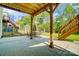 Covered concrete patio offers an outdoor dining area and access to a lush backyard with mature trees at 10056 Paisley Dr, Charlotte, NC 28269