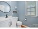 Bright bathroom features modern fixtures, sleek white vanity, and a large window for natural light at 10354 Scotland Ave, Fort Mill, SC 29707