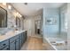 Elegant bathroom with double vanity, soaking tub, decorative mirror, and modern lighting at 10354 Scotland Ave, Fort Mill, SC 29707