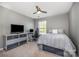 Bedroom with a ceiling fan, carpet flooring, a window, and modern decorations at 10354 Scotland Ave, Fort Mill, SC 29707
