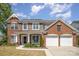 Charming two-story home with a brick and stone facade, complemented by a well-manicured lawn at 10354 Scotland Ave, Fort Mill, SC 29707