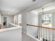 Open hallway with carpeted floors, wooden railing and chandelier near stairs at 10354 Scotland Ave, Fort Mill, SC 29707