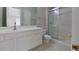 Bathroom featuring a shower over the bathtub and a white vanity at 10526 Hill Point Ct, Charlotte, NC 28262