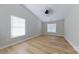 Bedroom with wood floors, ceiling fan, and natural light from two windows at 10526 Hill Point Ct, Charlotte, NC 28262