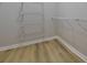 Walk-in closet with wood floors and metal shelving at 10526 Hill Point Ct, Charlotte, NC 28262