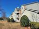 Apartment building with balconies and well-maintained landscaping at 10526 Hill Point Ct, Charlotte, NC 28262
