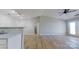 Bright living room with ceiling fan and wood-look flooring, open to kitchen, and access to an outdoor balcony at 10526 Hill Point Ct, Charlotte, NC 28262