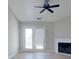 Bright living room featuring balcony access and cozy fireplace creating the perfect space for relaxation and entertaining at 10526 Hill Point Ct, Charlotte, NC 28262