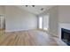 Bright living room featuring wood floors, fireplace, and access to the backyard at 10526 Hill Point Ct, Charlotte, NC 28262