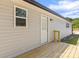 Exterior view of porch featuring new wood deck with a door leading inside at 109 W Poplar St, Stanley, NC 28164
