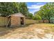 Backyard image showing detached brick building and fenced in area at 109 W Poplar St, Stanley, NC 28164