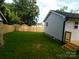 Spacious backyard featuring a brand new wooden fence, stairs, and a back deck at 109 W Poplar St, Stanley, NC 28164