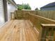 Beautiful backyard deck featuring natural wood and wooden railings overlooking the backyard at 109 W Poplar St, Stanley, NC 28164